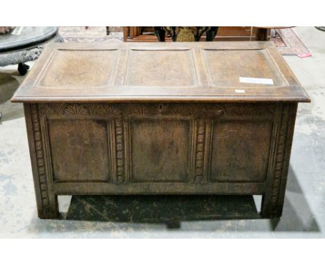 18th/19th century oak coffer, the hinged three panel lid opening to a candle box, three panels to the carved front, on stile 