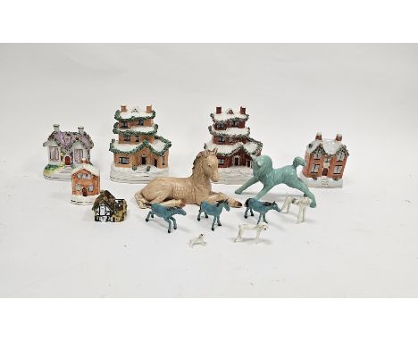Five late 19th century Staffordshire pottery house money boxes, appplied with extruded clay, one as a Gothic cottage, a Crown