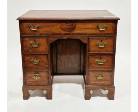 George III mahogany kneehole desk with secretaire drawer, the crossbanded top with ogee moulded edge over a long cockbeaded s