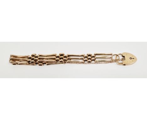 Yellow metal three-bar gate bracelet with 9ct yellow gold heart shaped padlock and safety chain,&nbsp;approximate weight 11.0