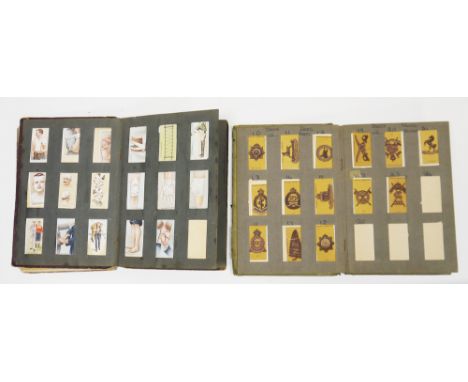 Two early 20th century cigarette card albums&nbsp;containing various part sets of loose cigarette cards, including Players Co