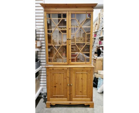 Modern pine library bookcase&nbsp;in the George III manner, the twin astragal glazed doors opening to adjustable shelves, ove