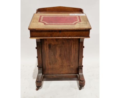 Victorian walnut davenport, the sloping lid with a red leather inset writing surface, opening to a fitted interior, over four