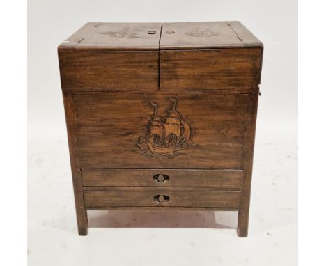 South East Asian hardwood sewing/work cabinet, the two hinged lids with carved decoration opening to two slide back trays and