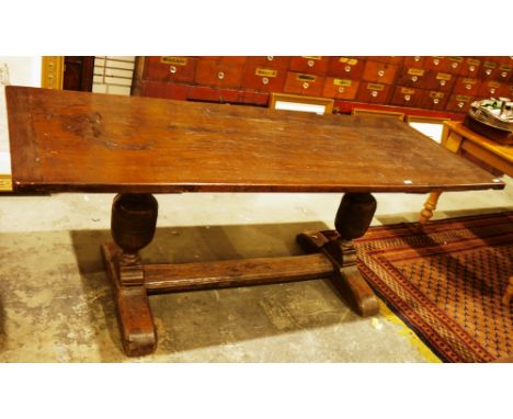 Antique oak refectory table in the 17th century manner, the single plank top with cleated ends, on two substantial turned cup