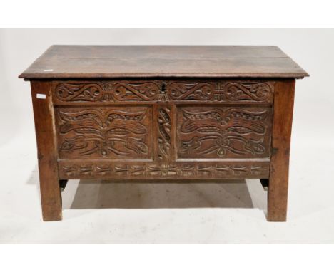 18th century oak coffer, the hinged rectangular top with thumbmould edge, opening to a candle space, two carved panels to fro