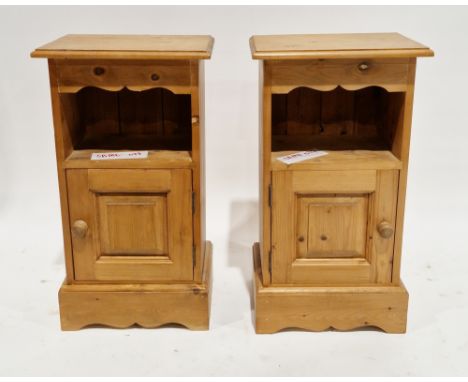 Pair of modern pine bedside cabinets, having a shaped frieze over a shelf with cupboard below, on plinth bases, 69.5cm high x
