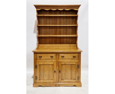 Modern lacquered oak dresser, the upper section with three plate shelves, on a base with two drawers having brass drop loop h