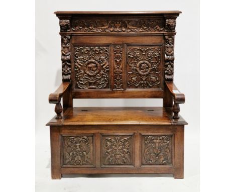 Victorian oak hall bench, the panelled back carved with side profile portraits, cherubs, birds, lion masks and foliate scroll