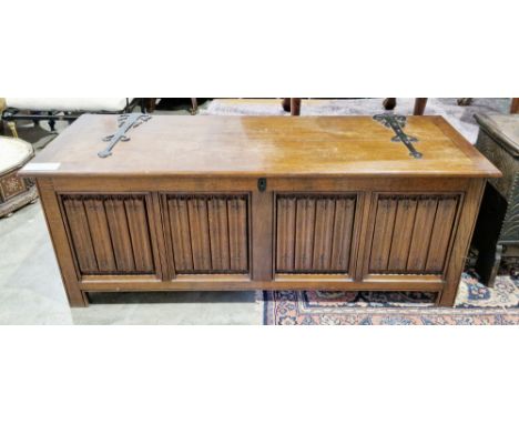 Large oak coffer in the 17th century manner, the lid with iron strapwork hinges opening to a pine lined interior, four linenf