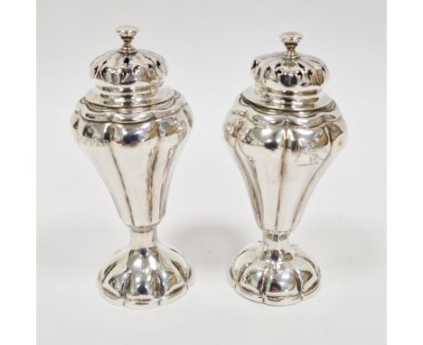 Victorian silver salt and pepper pot, London 1838, makers mark rubbed, having domed lids with finials, on baluster fluted tap