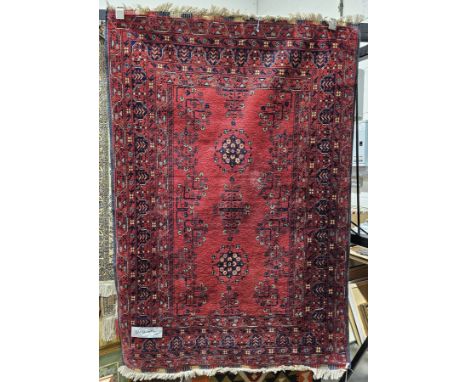 20th century Persian red ground carpet, woven in dark blue with star-shaped medallions and flowering branches to the centre, 