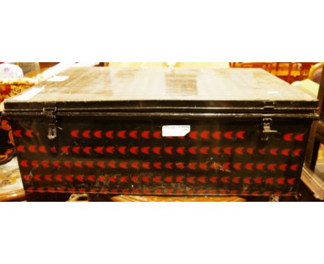 Large early 20th century black metal trunk&nbsp;having a red pattern design, two handles and two keys, 34cm high x 100cm long