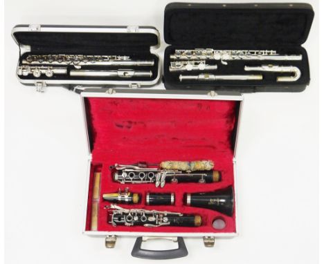 Three cased musical instruments including Odyssey OFL100 flute in hard case, Elkhart by Vincent Bach International 100FLU flu