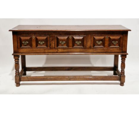 Jacobean revival oak dresser base, the rectangular top with thumbmould edge, over three moulded frieze drawers with brass dro
