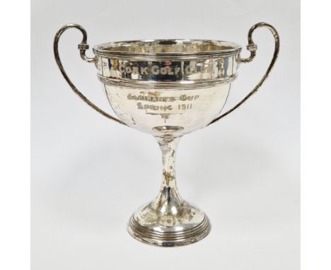 Edward VII silver twin-handled trophy, London 1910, maker's mark rubbed, of plain form with ribbed border and girdle, twin sc