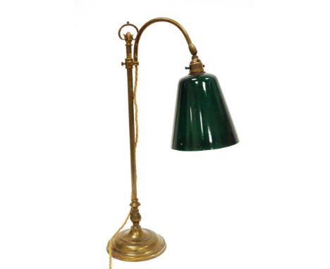Edwardian style gilt-brass desk lamp with loop carrying handle, swan neck and green glass shade, on circular stepped base, 57