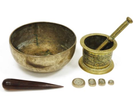 Tibetan brass singing bowl&nbsp;with hammered decoration, 24cm diameter,&nbsp;a lignum vitae turned baton,&nbsp;an Indian bra