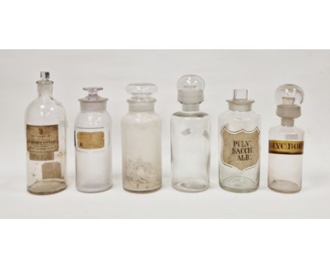 Six late 19th/early 20th century labelled glass apothecary bottles and stoppers in sizes, each of cylindrical form, with asso