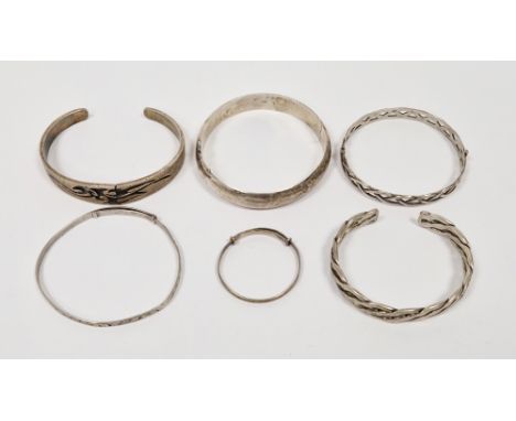 Collection of six silver bangles including a plain hinged bangle, engraved adjustable bangle, child's engraved adjustable ban
