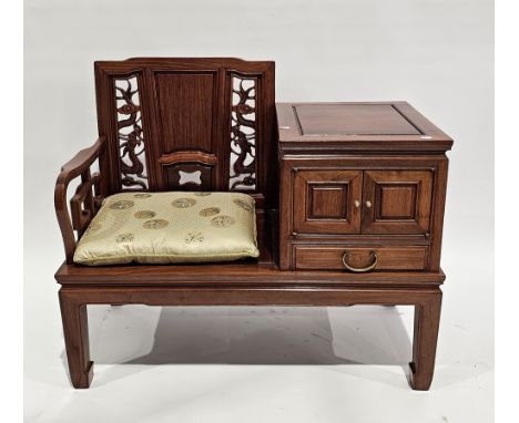 Chinese hardwood telephone table&nbsp;comprising a seat with pierced dragon carved splat and solid seat, flanked by a cabinet