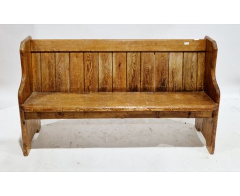 Late 19th/early 20th century pine church pew, the top rail with bible shelf behind, slatted back, solid seat and solid suppor