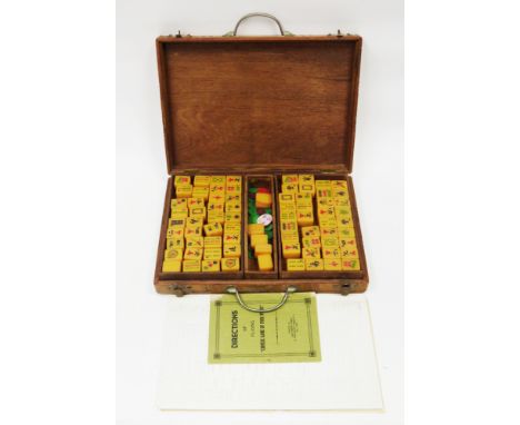 Mid-century South East Asian mahjong set&nbsp;comprising amber-coloured playing pieces and a directions of playing Chinese Ga