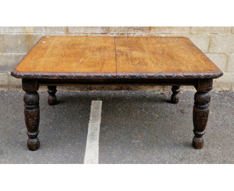 Victorian oak extending wind-out dining table, the rectangular top with canted corners and carved edge, on turned baluster ta
