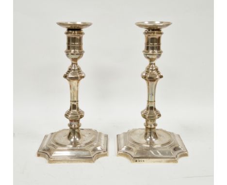 Pair of George V silver weighted candlesticks, London 1938, D &amp; J Welby Ltd, with knopped stems, on stepped square bases 