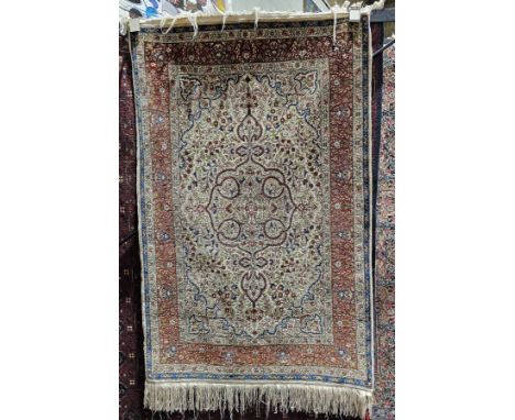 20th century silk Persian Kashan-style rug&nbsp;in blue, cream, green and red, the centre with foliate roundel reserved on a 
