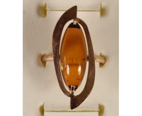 A Russian 14 k gold and amber ring, bearing 585 Russian control marks, 3.2 gm, Q. 