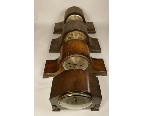 A collection of clocks to include, large wooden manual wind mantel clocks, a wall hanging mantel with weights and a marble/sl