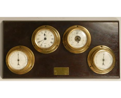 A FCC, precision, a combination thermometer, quartz clock, barometer, humidity bulk head instruments, mounted on a mahogany b