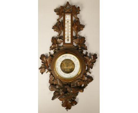 A French carved soft wood barometer and thermometer, with nesting bird decoration, height 61 cm 