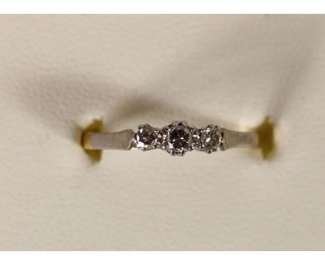 An 18ct gold three stone diamond ring, claw set with brilliant cut stones, 1.9gm, M. 