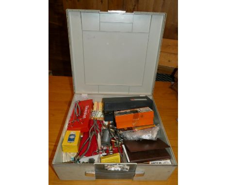 A quantity of model making accessories to include, tools, vice, paints, model plans, and a part built model of a boat includi