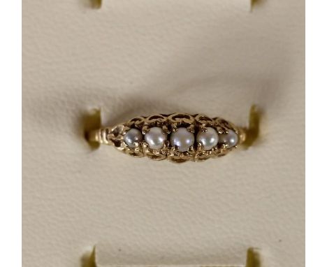 A gold and five cultured pearl ring, marks worn, 1.1gm, N 1/2. 