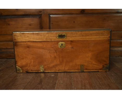 A 19th century brass bound camphor trunk with inset brass handle, lock and central plaque. H.39 W.86 D.42cm 