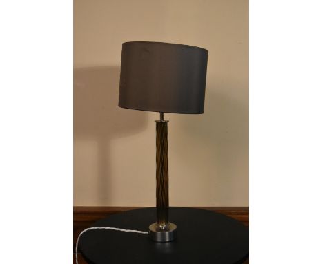 A contemporary chrome table lamp with twisted column and matching shade. H.63 W.29cm 