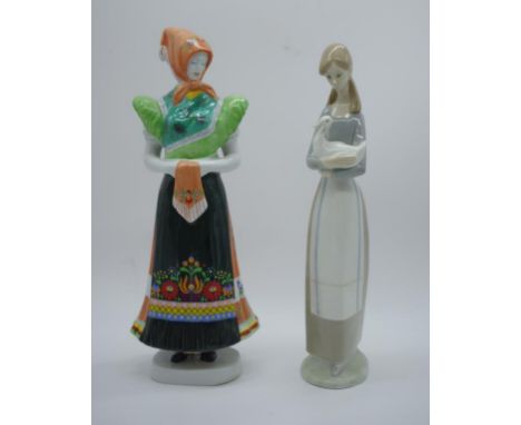 Two porcelain female figurines Hungarian & Spanish comprising of a Hollohaza Matyo woman 28.5cm high and a Nao girl with duck