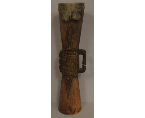 Papua New Guinea kundu drum carved decoration. Handle to 1 side. Animal skin to top playing surface.H75cms approx