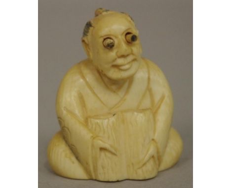 Antique Japanese seated man ivory netsuke with pop out eyes, C1920. Signed to base. May not be exported without CITES documen