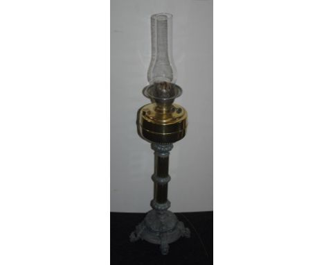 Antique oil lamp twin burner with ornate cast base & a glass chimney, 82cm high approx.