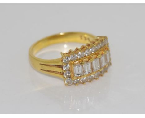 18ct yellow gold and diamond ring the centre set with five baguette diamonds, surrounded by 210 small round diamonds. Size 6-