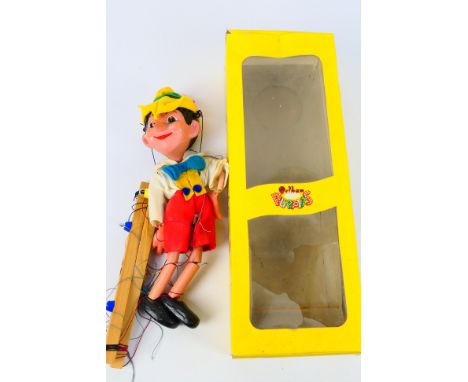 Pelham Puppets - A boxed #SL7 Pinocchio Pelham Puppet - Comes in yellow box. Puppet is 30 cm in height. Puppet shows signs of