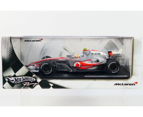 Hot Wheels - A boxed 1:18 scale Hot Wheels 'Racing' K6634 McLaren MP4-22 F1 diecast racing car, 'Lewis Hamilton'. The model s