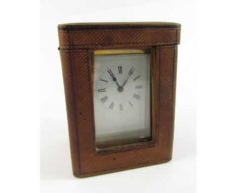 A late 19thC brass carriage lamp, with leaf scroll handle, enamel dial bearing Roman numerals, single barrel movement, raised