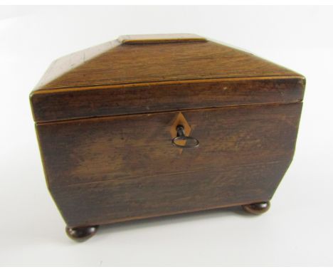 A Regency rosewood and boxwood line inlaid sarcophagus form tea caddy, twin lidded interior, raised on bun feet, with key, 19
