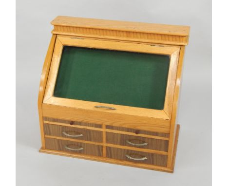 An early 20thC light oak shop display case, of cash register form, the levered glazed top over an arrangement of two slides a