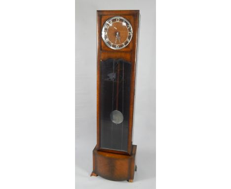 An Art Deco oak grandmother clock, circular oak and chrome dial bearing Arabic numerals, Norland three train movement with We